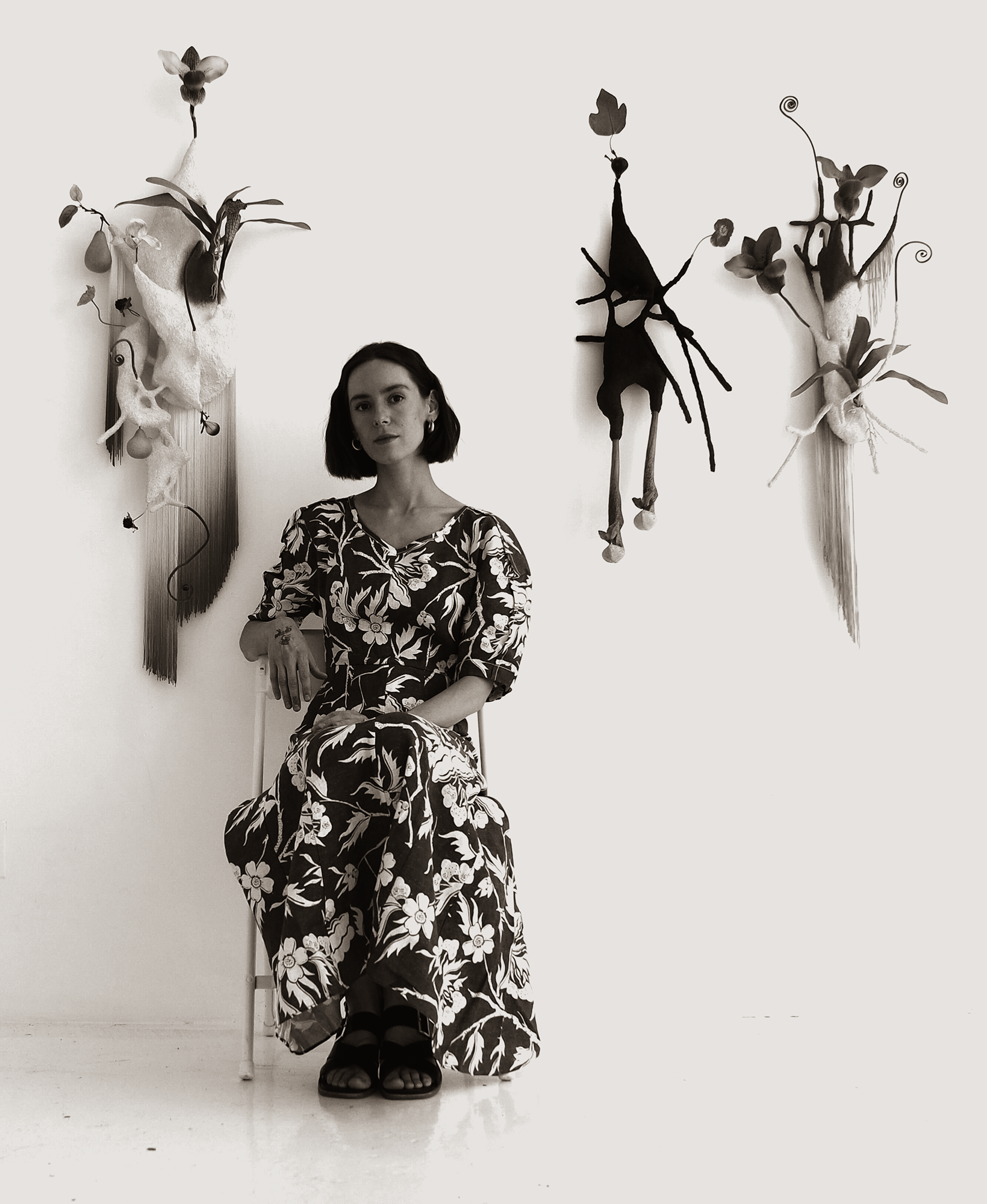 Julia Blume seated in her studio surrounded by sculptural work