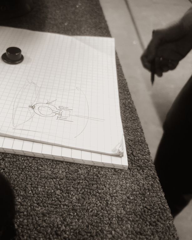 An artisan sketching a lighting form