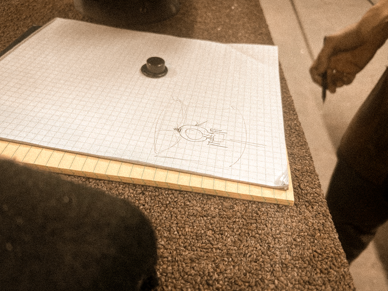 An artisan sketching a lighting form