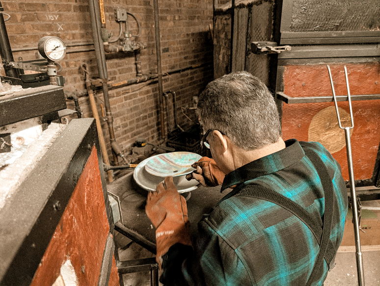 A glass bowl being shaped in one of our ovens
